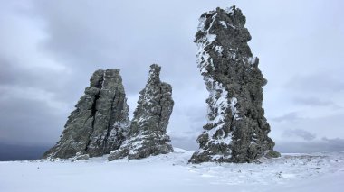 Weathering pillars. Geological monument in the Troitsko-Pechora region. Giants of the Manpupuner Plateau, Komi Republic, Russia. One of the seven wonders of Russia.