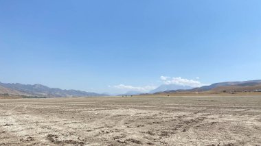View of the desert scorched earth in Kyrgyzstan. Rocky mountains and hills. Calming natural background.