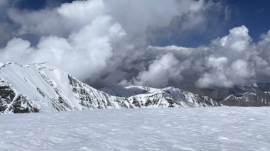 View of the snow-capped rocky mountains of the Pamirs. The amazing nature of Kyrgyzstan. Mountain winter landscape.