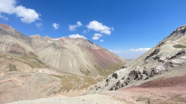 Breathtaking view of the mountains from above. Colored rocks, peaks and hills of Kyrgyzstan. Amazing mountain landscape. The beautiful nature of the Pamirs.