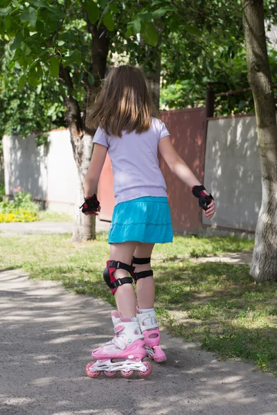 Klein meisje op rolschaatsen — Stockfoto