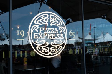 Pizza Express logo decal on restaurant window at Ashford Outlet Center, Kent, England, UK. clipart