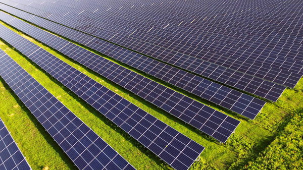 Aerial drone view flight over solar power station panels.