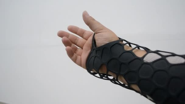 Black orthopedic plastic prosthesis printed on powder 3D printer on hand. — Stock Video