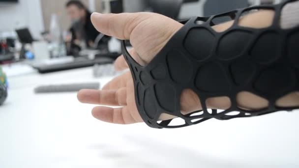 Prótesis plástica ortopédica negra impresa en una impresora 3D en polvo a mano. — Vídeo de stock