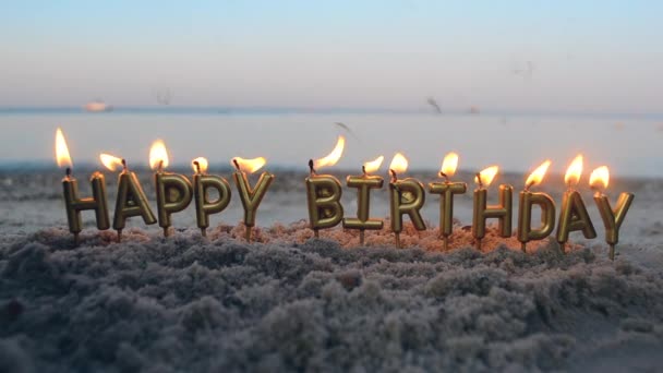 Candle Letters Happy Birthday Burning on Background of Blurry Sea Waves on Beach — Stock Video