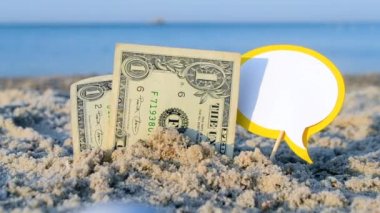 İki tane bir dolarlık kumlu banknot, sarı beyaz kağıt üzerinde deniz sevdiğim kelimeler.