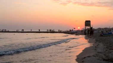 People walk along the sea coast seashore. Sea rest, Sea vacation.
