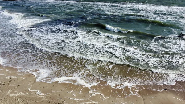 Voo de visão aérea drone sobre ondas que rolam para a costa arenosa. Vista superior — Fotografia de Stock