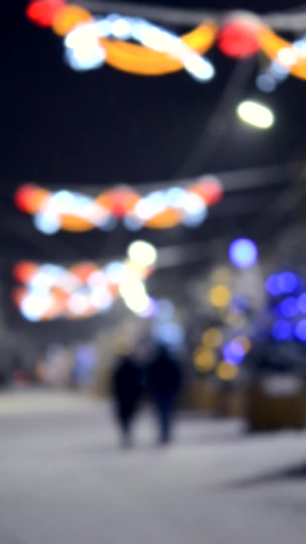 Rozmazané pozadí. Městská ulice během sněžení v zimní noci. Osvětlení — Stock video