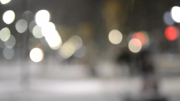 City view lights, falling snow, night street, bokeh spots of headlights of cars — Stock Video