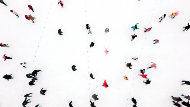 Gente patinando en una pista de patinaje sobre hielo al aire libre. Vista superior. Mucha gente — Vídeos de Stock