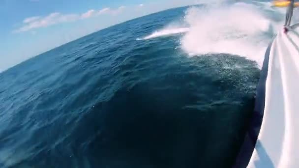 Bateau à moteur sautant sur les vagues de la mer le jour ensoleillé d'été Eau de mer bleue éclaboussure blanche — Video