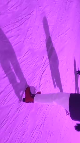 Οι άνθρωποι πατινάζ σε ένα παγοδρόμιο με πολύχρωμο φως σε ανοιχτό αέρα το χειμώνα — Αρχείο Βίντεο