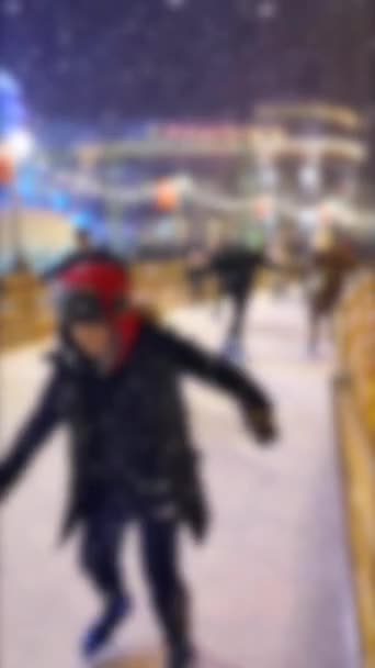 Wazige achtergrond Veel mensen schaatsen op openlucht schaatsbaan sneeuwval — Stockvideo