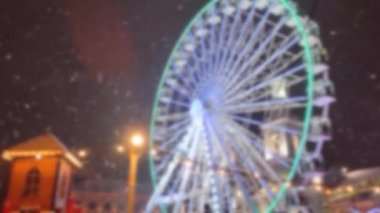 Kış gecelerinde şehirde panoramik dönme dolap. Şehir manzarası