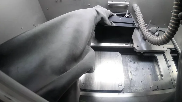 Male worker in rubber glove cleans printing platform inside 3d printer for metal — Stock Photo, Image