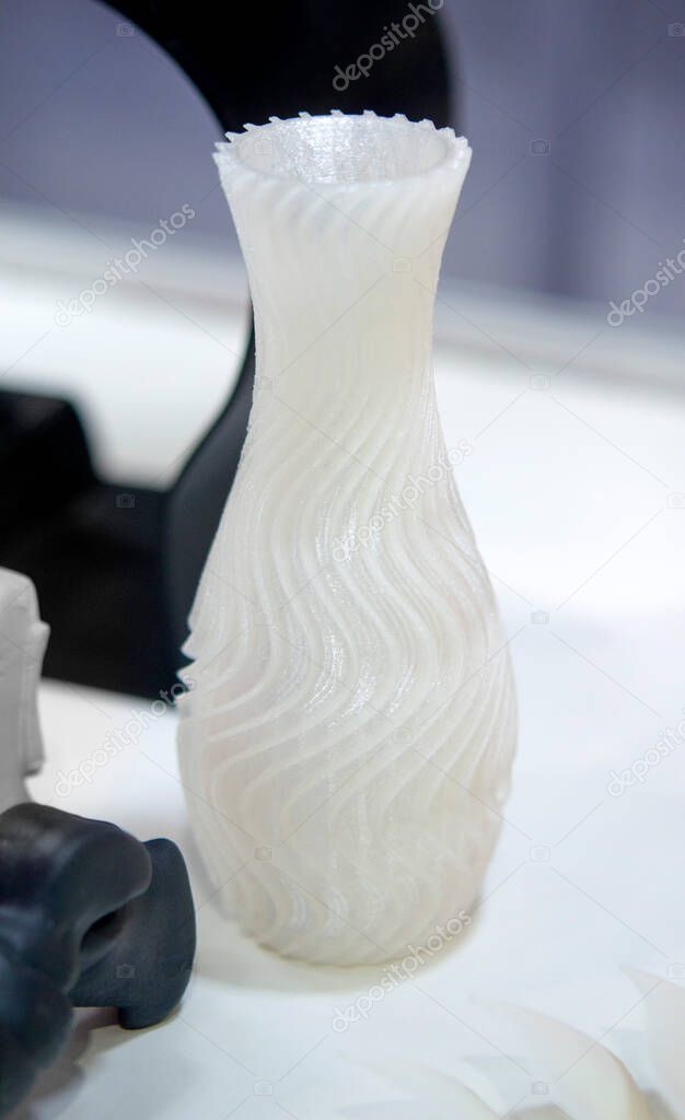 Objects printed on a 3d printer made of white plastic close-up.