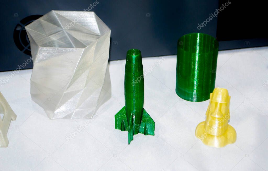 Objects printed on 3d printer made of white plastic close-up.