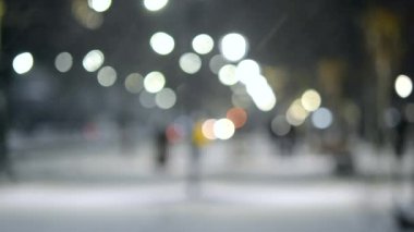Şehir manzaralı ışıklar, yağan kar, gece caddesi, arabaların farları.