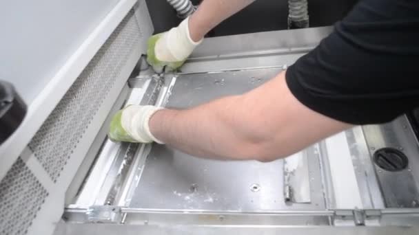 Mężczyzna pracownik demontuje i usuwa szczegóły wewnątrz dużej przemysłowej drukarki 3D — Wideo stockowe