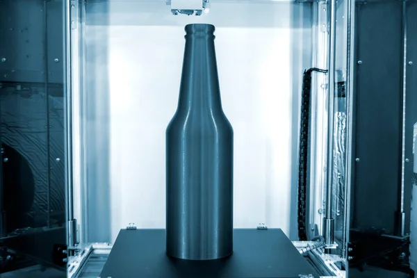 Object bottle printed on 3D printer close-up, inside on desktop of 3d printer. Progressive modern additive technology. Concept 4.0 industrial revolution. Modern 3D printing additive technology