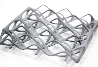 Model printed on 3D printer isolated on white background. Object details printed on 3D printer from plastic close-up. Prototype of shape made by 3d printer. Concept new modern printing technology