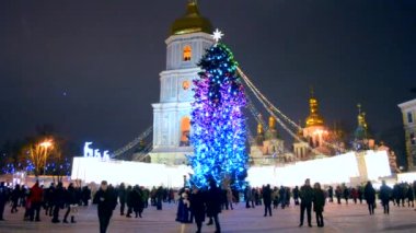 Kyiv, Ukraine January 5, 2019 - A large New Years Christmas tree stands on a square with a lot of people walking in the city center on a winter night. Walk, relax, celebrate in the city center