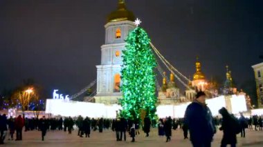 Kyiv, Ukraine January 5, 2019 - A large New Years Christmas tree stands on a square with a lot of people walking in the city center on a winter night. Walk, relax, celebrate in the city center
