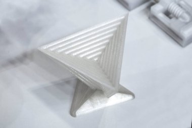 Objects prototype printed on 3d printer from plastic filament close-up. Modern new prototyping technology. Additive automation manufacturing Fused deposition modeling. 3D printing technology