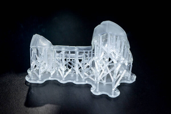Abstract model printed on 3d printer close-up. Object photopolymer printed on stereolithography 3D printer. Technology of liquid photopolymerization under UV light. New additive 3D printing technology