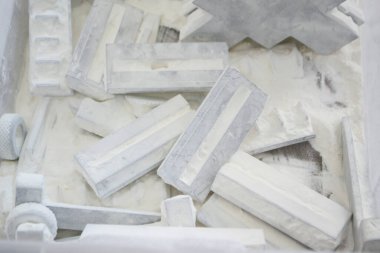 Detail objects printed on powder 3D printer and covered white polyamide powder close-up. Technology Multi Jet Fusion MJF. 3D prototype models created by new additive progressive 3d printing technology