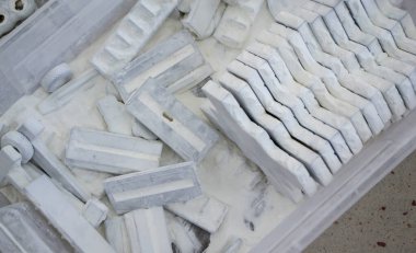 Detail objects printed on powder 3D printer and covered white polyamide powder close-up. Technology Multi Jet Fusion MJF. 3D prototype models created by new additive progressive 3d printing technology