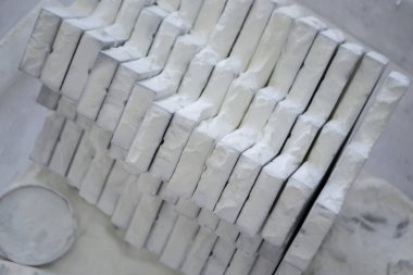 Detail objects printed on powder 3D printer and covered white polyamide powder close-up. Technology Multi Jet Fusion MJF. 3D prototype models created by new additive progressive 3d printing technology