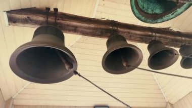 Ring the bells. Ringing church bells. Bell tower inside. Church bells ringing. Chime. Ding-dong. Bells bottom view. Ringing