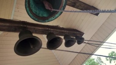 Ring the bells. Ringing church bells. Bell tower inside. Church bells ringing. Chime. Ding-dong. Bells bottom view. Ringing