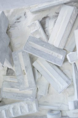 Detail objects printed on powder 3D printer and covered white polyamide powder close-up. Technology Multi Jet Fusion MJF. 3D prototype models created by new additive progressive 3d printing technology