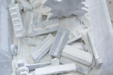 Detail objects printed on powder 3D printer and covered white polyamide powder close-up. Technology Multi Jet Fusion MJF. 3D prototype models created by new additive progressive 3d printing technology