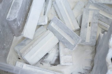 Detail objects printed on powder 3D printer and covered white polyamide powder close-up. Technology Multi Jet Fusion MJF. 3D prototype models created by new additive progressive 3d printing technology