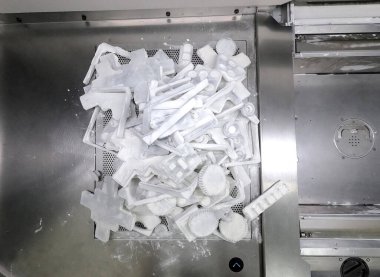 Detail objects printed on powder 3D printer and covered white polyamide powder close-up. Technology Multi Jet Fusion MJF. 3D prototype models created by new additive progressive 3d printing technology