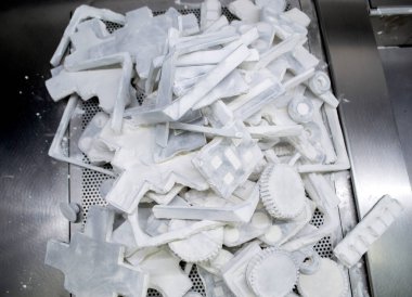 Detail objects printed on powder 3D printer and covered white polyamide powder close-up. Technology Multi Jet Fusion MJF. 3D prototype models created by new additive progressive 3d printing technology