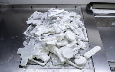 Detail objects printed on powder 3D printer and covered white polyamide powder close-up. Technology Multi Jet Fusion MJF. 3D prototype models created by new additive progressive 3d printing technology