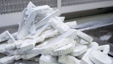 Detail objects printed on powder 3D printer and covered white polyamide powder close-up. Technology Multi Jet Fusion MJF. 3D prototype models created by new additive progressive 3d printing technology