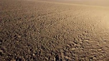 Flying over the plowed fields of black soil on sunny autumn day. Fields black soil close-up. Farming countryside rural. Digged agrarian agricultural earth fields. Plowed lands. Dug up ground farmlands