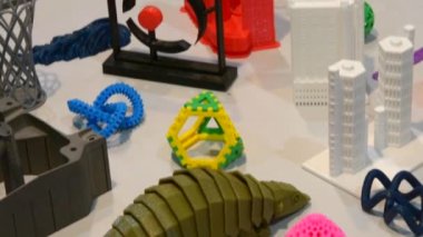 Bir 3d printerlere harcama maddeler üzerinde oluşturulan çok çeşitli plastik rakamlar. Parlak renkli nesne. Otomatik üç boyutlu plastik modelleme gerçekleştirir. Modern 3d baskı teknolojisi.