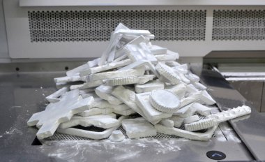 Detail objects printed on powder 3D printer and covered white polyamide powder close-up. Technology Multi Jet Fusion MJF. 3D prototype models created by new additive progressive 3d printing technology