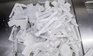 Detail objects printed on powder 3D printer and covered white polyamide powder close-up. Technology Multi Jet Fusion MJF. 3D prototype models created by new additive progressive 3d printing technology