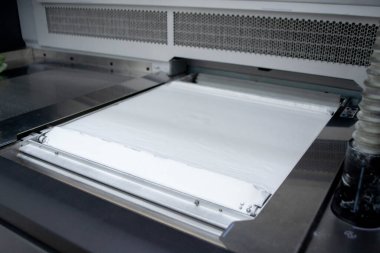 Yazdırma tozu için beyaz poliyamid tozu. 3D yazıcı, yakın plan. 3D yazıcının yazıcı içindeki çalışan yüzeye yüksek hızlı basımı için toz. Yeni modern baskı teknolojisi. Çoklu Jet Füzyon MJF