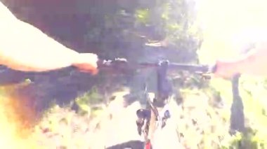 Bir kız bir güneşli yaz gününde Nehri boyunca bir bisiklet ile gidiyor. Bakış açısı pov mtb gitmek pro kamera.