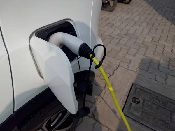 charging connect to electric car on charge station, Electric mobility environment friendly